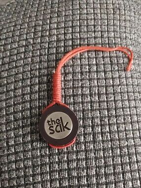 The Sak Rust Red Leather Logo Charm with Woven Loop-Replacement Tag